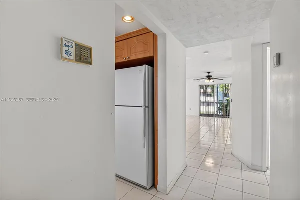 a view of a kitchen with refrigerator and cabinet