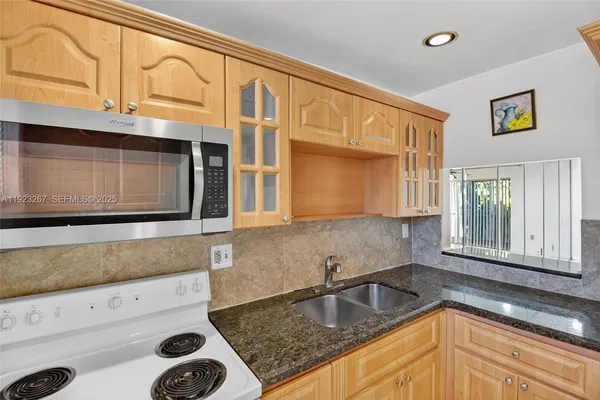 a kitchen with a stove and a microwave