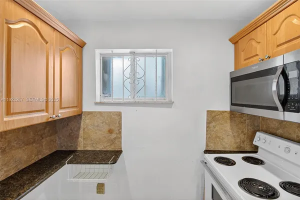 a kitchen with a stove and a microwave