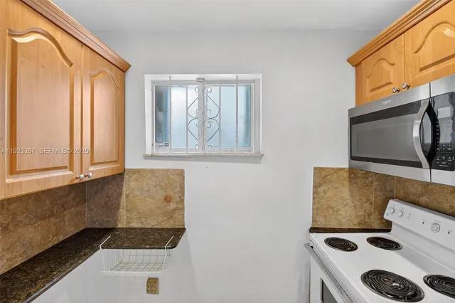 a kitchen with a stove and a microwave