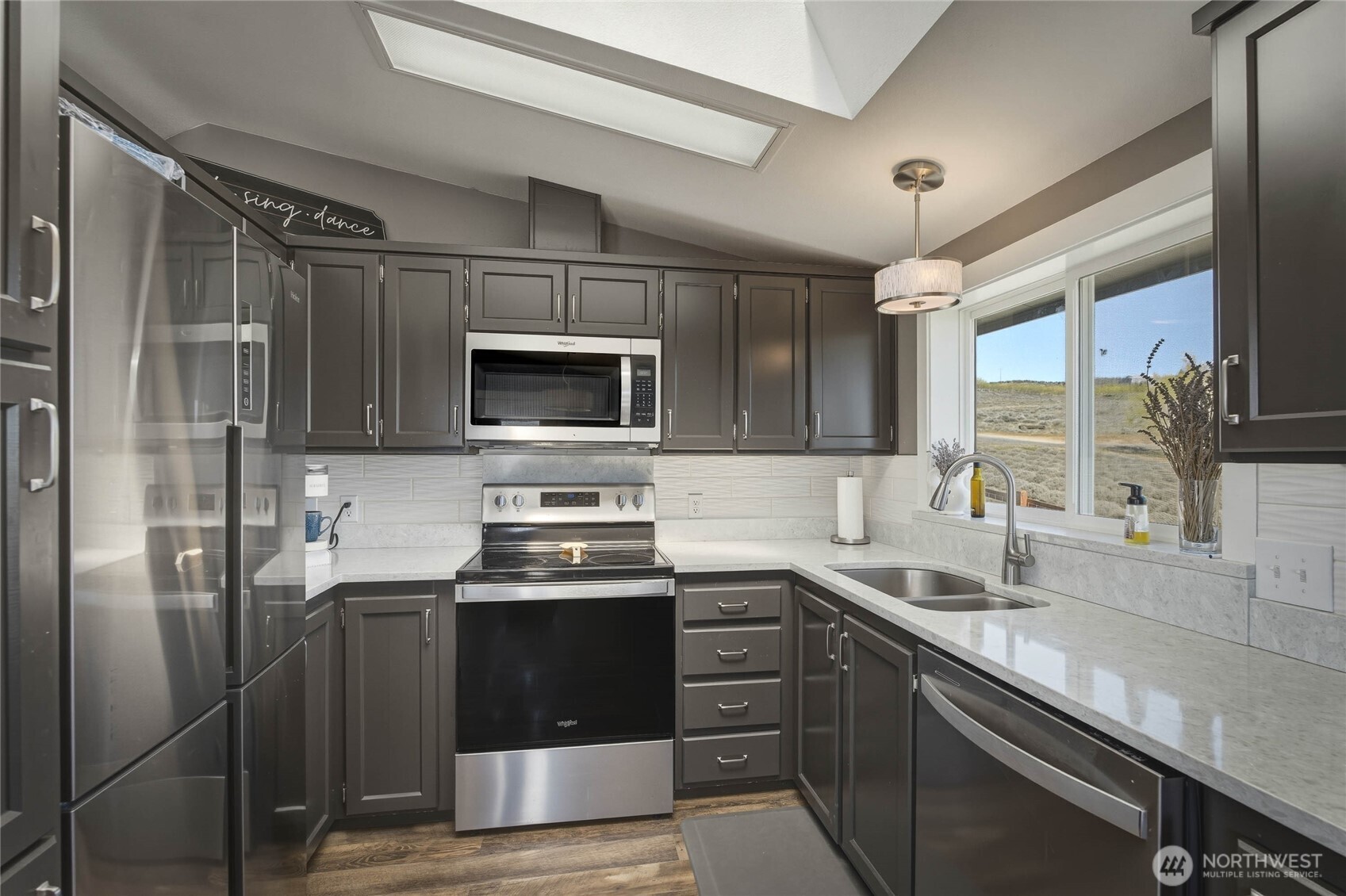 117 Freese Road Quincy, WA 98848 - Photo 7 of 40 a kitchen with stainless steel appliances a sink cabinets and a window