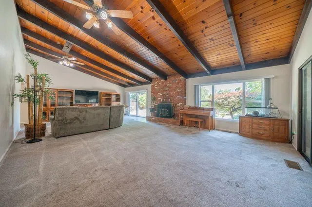 a living room with furniture a flat screen tv and a lamp