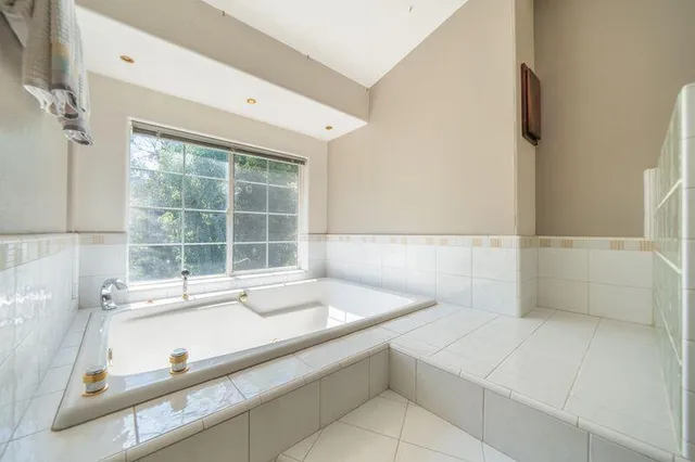 a view of a house with swimming pool and sitting area