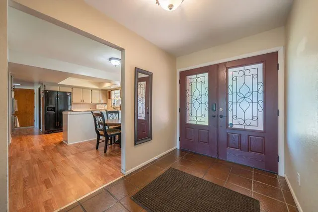 an aerial view of a house roof deck with couches and wooden fence