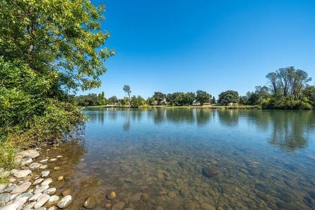 a view of a lake with houses in the back