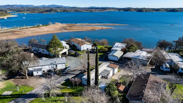 an aerial view of a house with garden space and outdoor seating