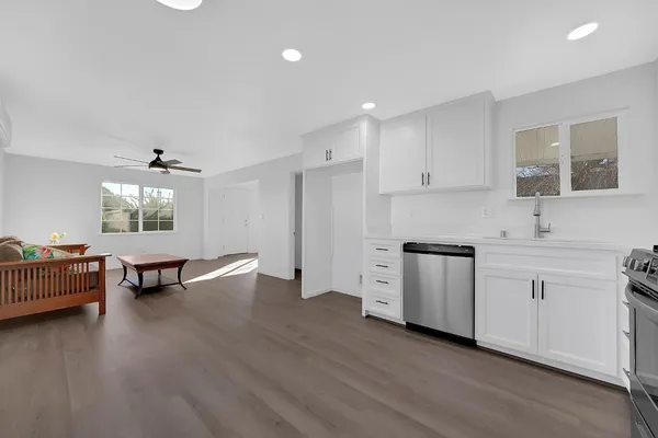 a kitchen with cabinets wooden floor and a sink