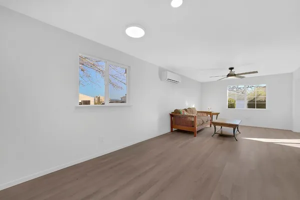 an empty room with furniture and a window
