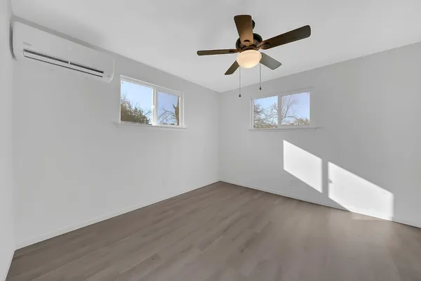 a view of empty room with wooden floor