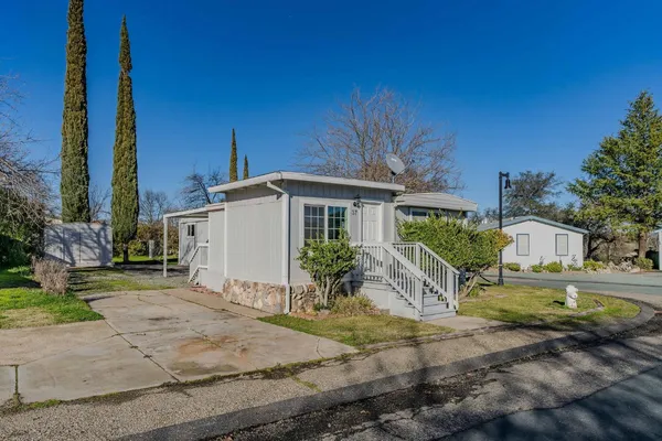 a front view of a house with garden
