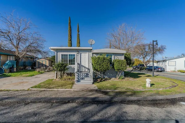 a view of a house with swimming pool and sitting area