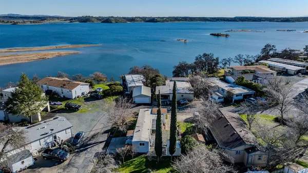an aerial view of a house with a lake view