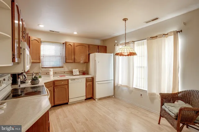 a kitchen that has a sink cabinets counter space and a window