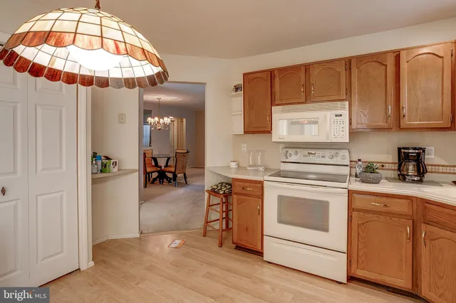 a kitchen with stainless steel appliances a stove a chimney a sink and cabinets