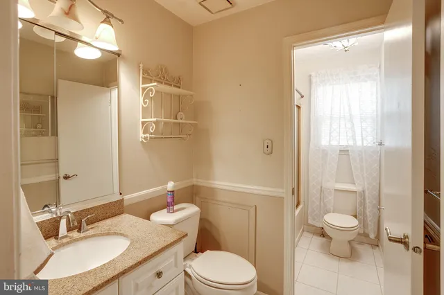 a bathroom with a sink toilet vanity and shower