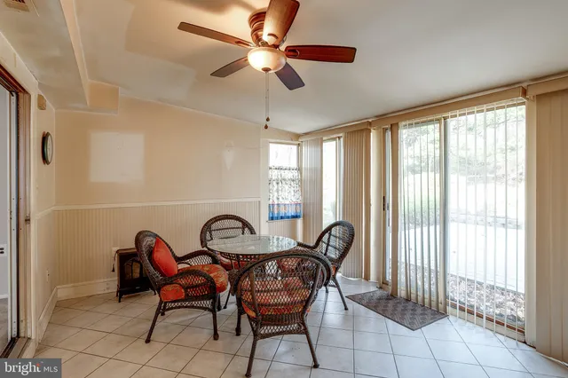 a view of a dining room with furniture and a window
