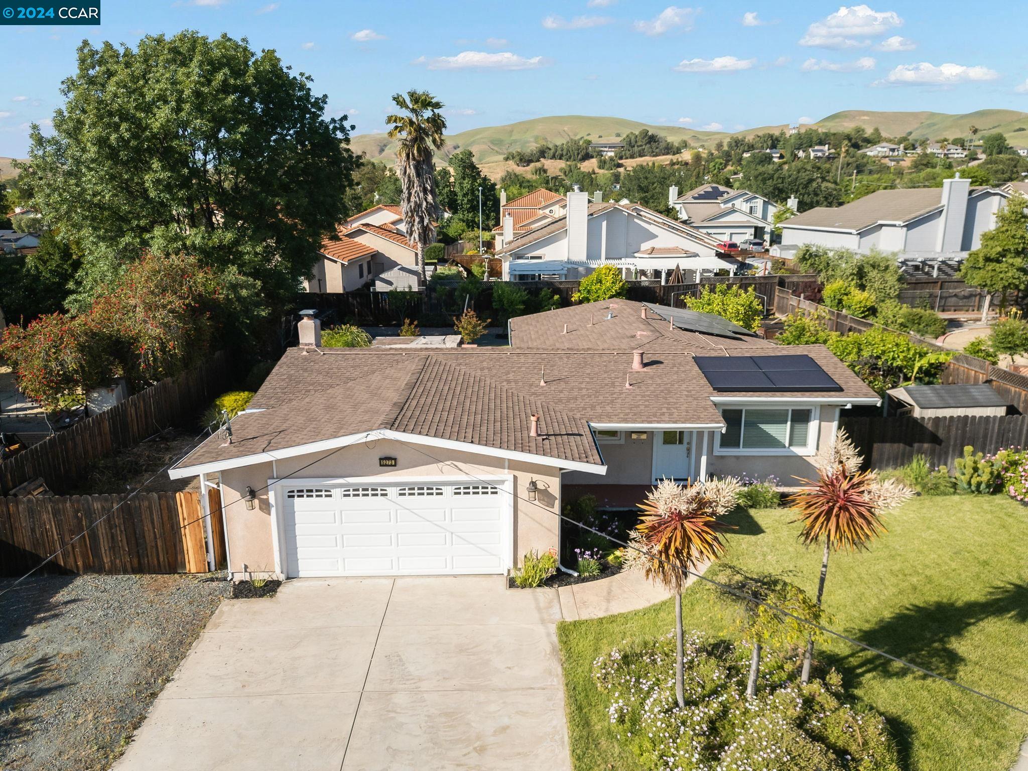 an aerial view of a house with a yard