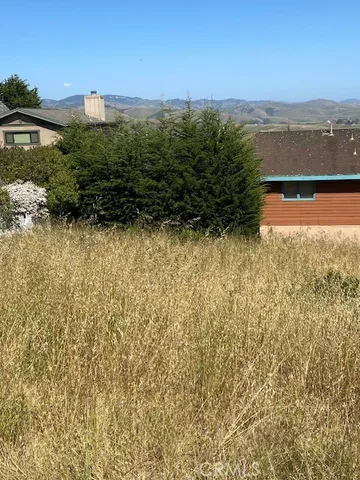 a view of a large body of water with a building in the background