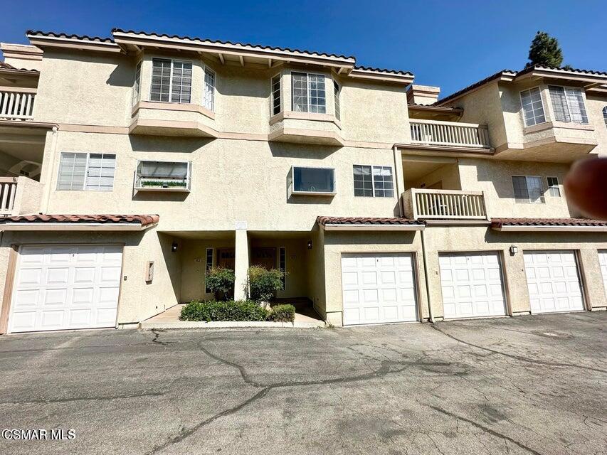 672 Indian Oak Lane, Unit 103 Oak Park, CA 91377 - Photo 1 of 34 a front view of a house