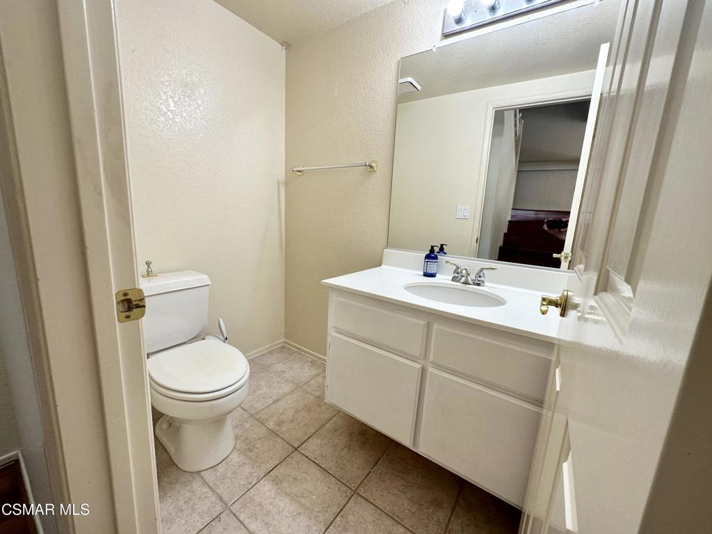 672 Indian Oak Lane, Unit 103 Oak Park, CA 91377 - Photo 12 of 34 a bathroom with a toilet sink and mirror