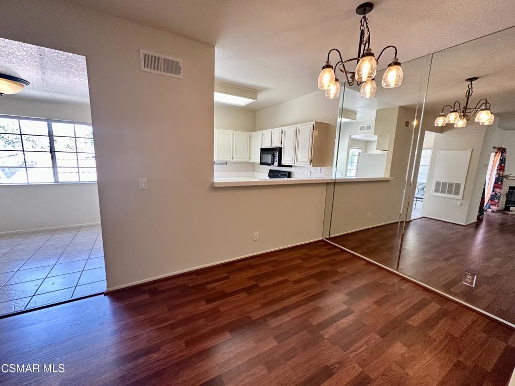 672 Indian Oak Lane, Unit 103 Oak Park, CA 91377 - Photo 7 of 34 a view of a kitchen with wooden floor and a kitchen