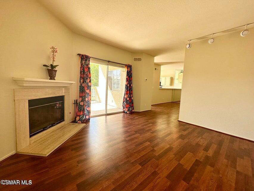 672 Indian Oak Lane, Unit 103 Oak Park, CA 91377 - Photo 8 of 34 a view of a livingroom with wooden floor and a fireplace