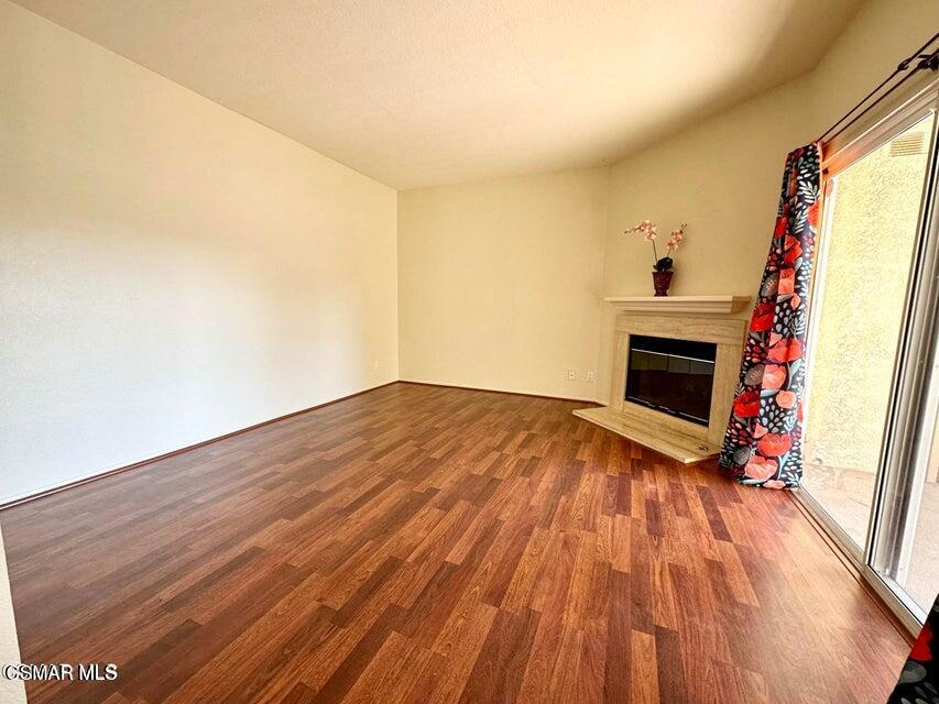 672 Indian Oak Lane, Unit 103 Oak Park, CA 91377 - Photo 10 of 34 a view of empty room with wooden floor and fireplace