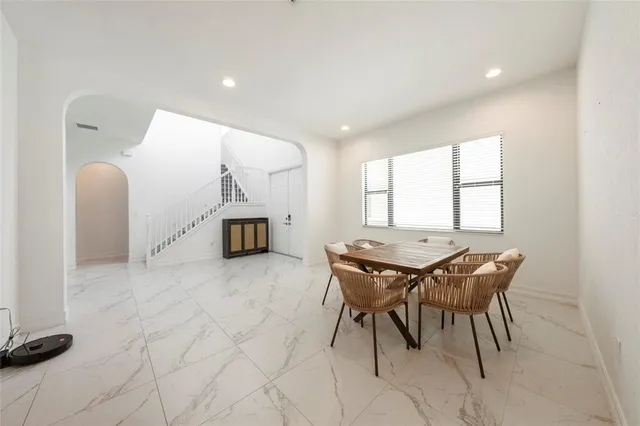 a dining room with furniture and window
