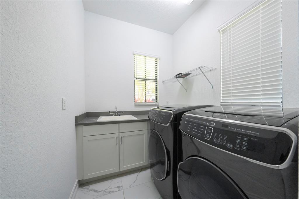 11843 Southwest 13th Court Pembroke Pines, FL 33025 - Photo 16 of 37 a utility room with dryer and washer