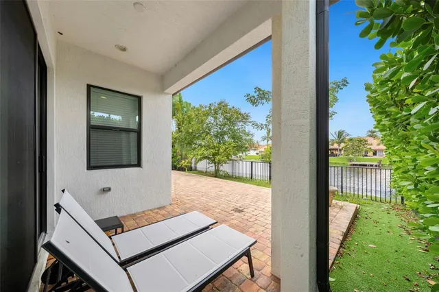 a view of a house with backyard and sitting area