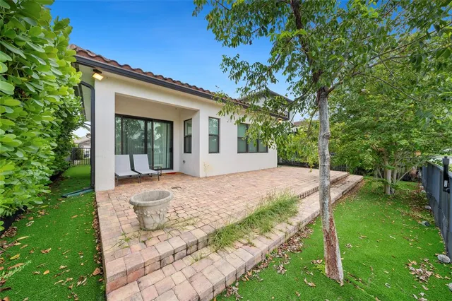 a view of backyard with plants and trees