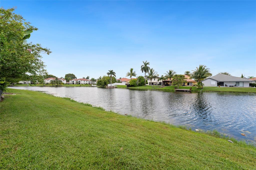 11843 Southwest 13th Court Pembroke Pines, FL 33025 - Photo 27 of 37 a view of a lake with houses in the back