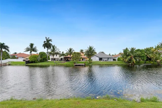 an aerial view of multiple house with outdoor space and lake view