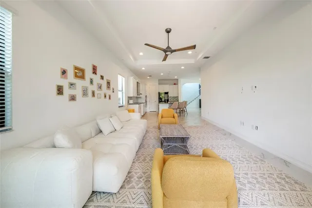 a living room with furniture and a chandelier