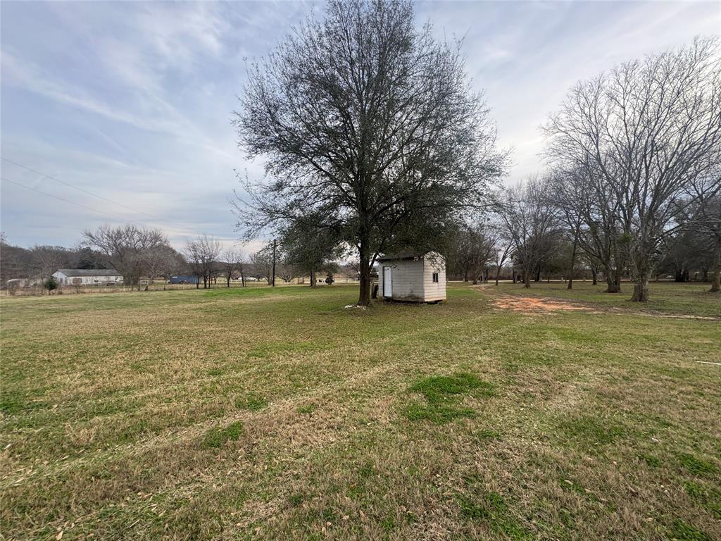 28296 Spring Valley Drive Kemp, TX 75143 - Photo 28 of 32 View of green lawn featuring a storage unit and a rural view