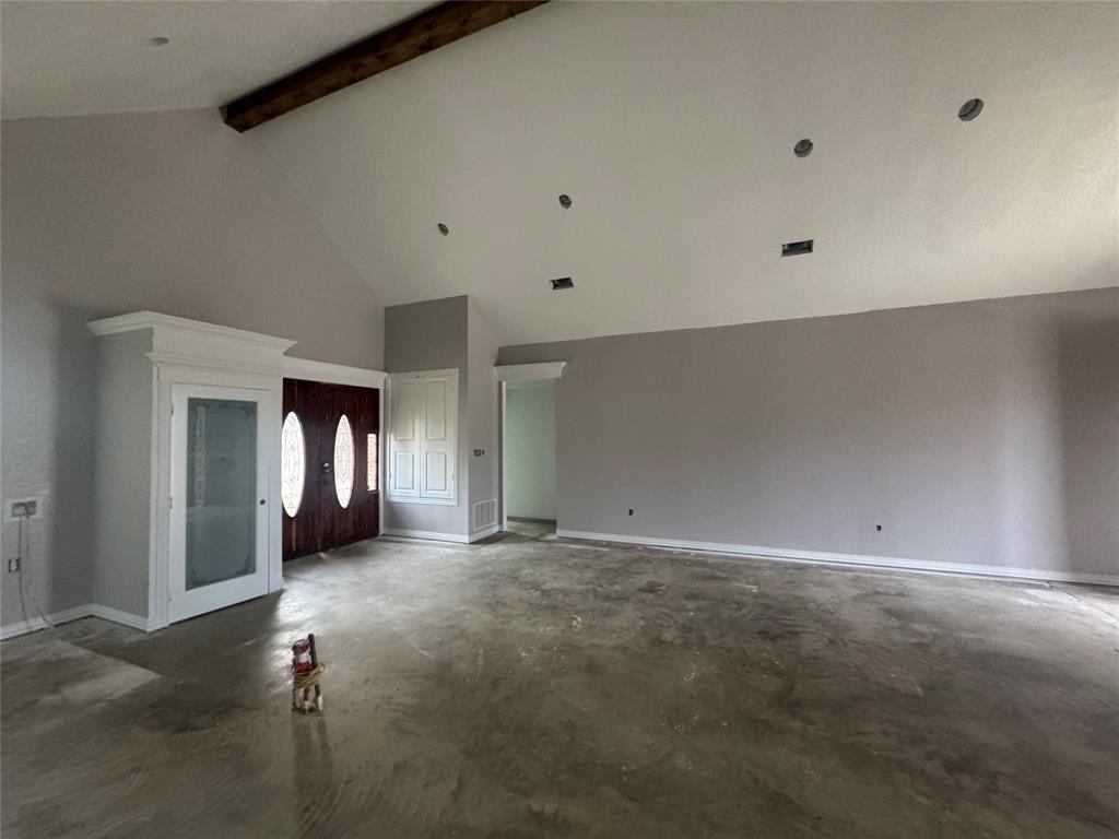 28296 Spring Valley Drive Kemp, TX 75143 - Photo 31 of 32 Unfurnished living room featuring high vaulted ceiling, unfinished concrete flooring, french doors, and beam ceiling