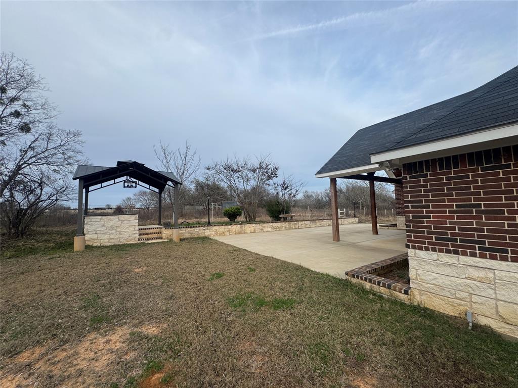 28296 Spring Valley Drive Kemp, TX 75143 - Photo 9 of 32 View of green lawn featuring a patio area