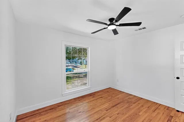 a view of a room with wooden floor and windows