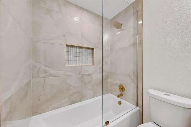 a bathroom with a bathtub and a shower