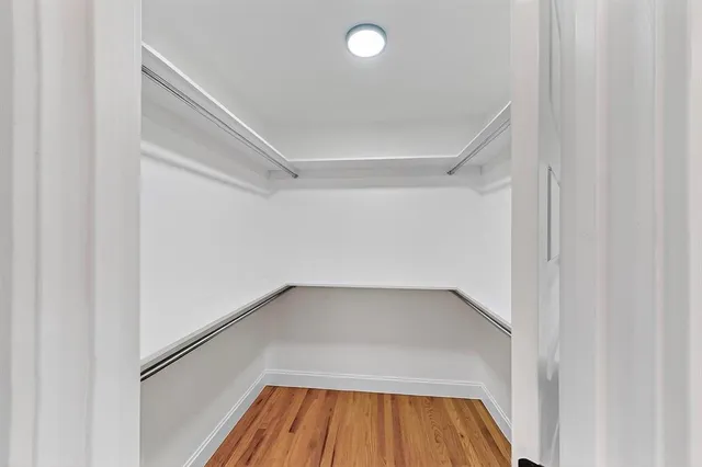 a view of a room with wooden floor and staircase