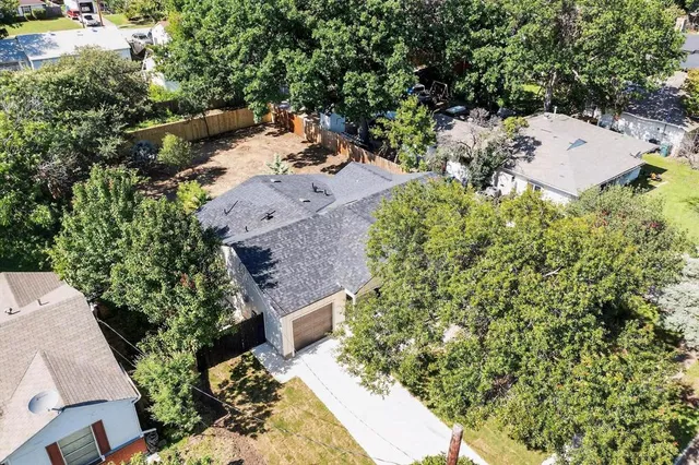 an aerial view of a house with a yard