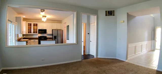 a view of a living room hardwood floor and a window
