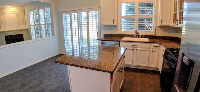 a kitchen with a sink cabinets and a window