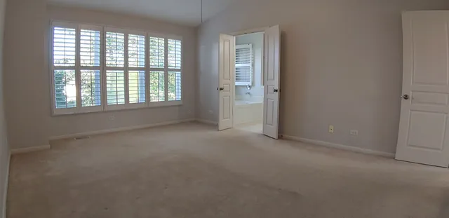 an empty room with a empty space and windows