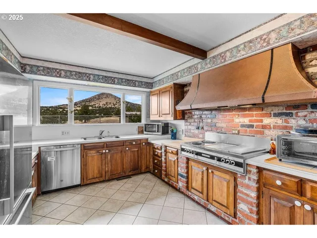 a kitchen with stainless steel appliances granite countertop a sink and cabinets