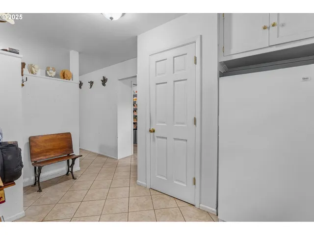 a view of room with furniture and wooden cabinets
