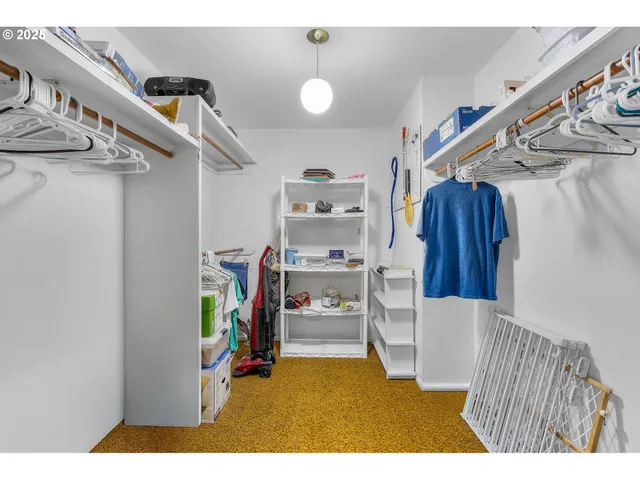 a view of a hallway with a white walls and stairs