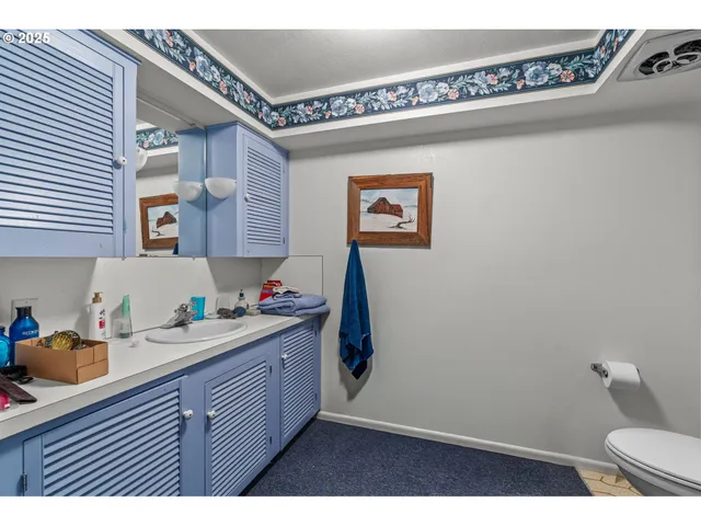 a kitchen with a sink a stove and cabinets