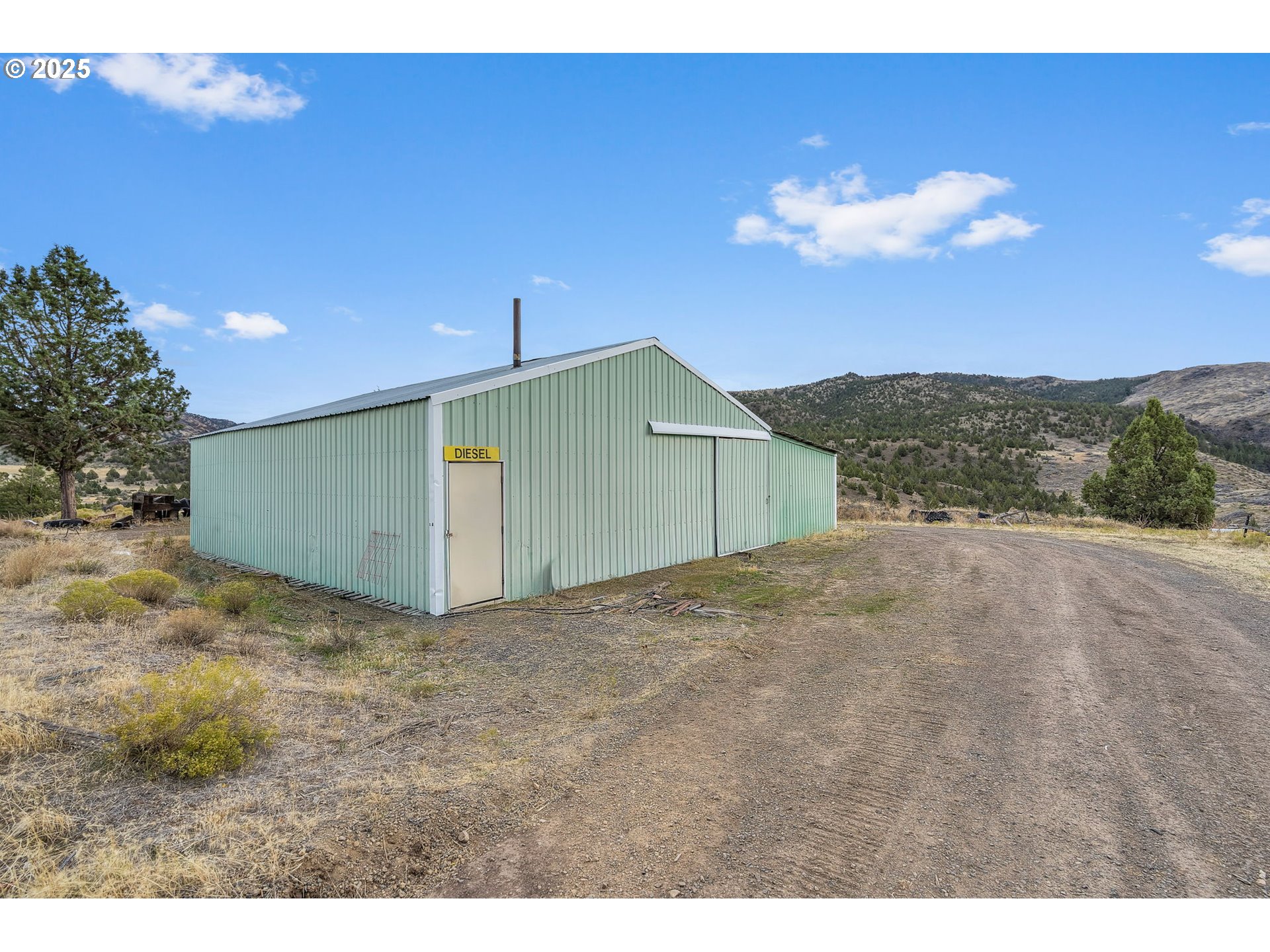 19369 Highway 26 Mitchell, OR 97750 - Photo 30 of 48 a view of a house with a yard and garage