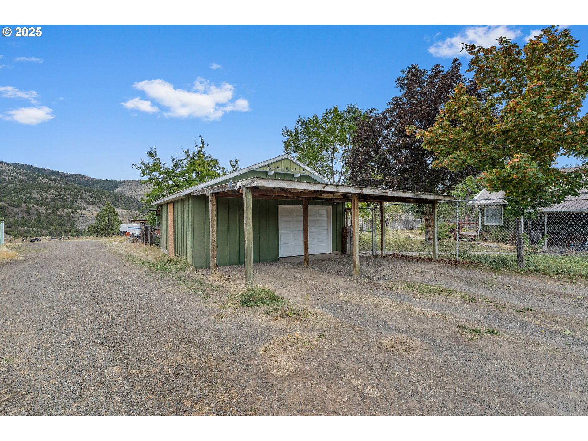 19369 Highway 26 Mitchell, OR 97750 - Photo 36 of 48 a view of a house with a yard and garage